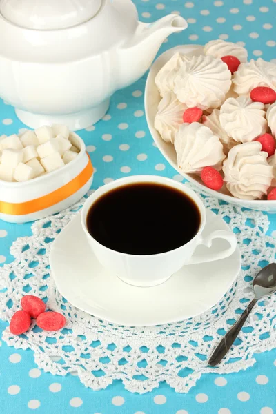 Beautiful white dinner service with an air meringues on blue tablecloth close-up — Stock Photo, Image