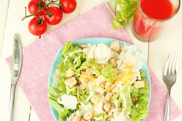 Caesarsalade op blauw bord, op een houten achtergrond kleur — Stockfoto