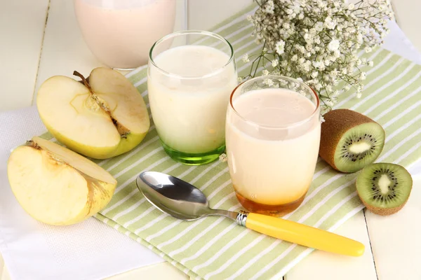 Deliciosos yogures con frutas en vasos sobre mesa de madera —  Fotos de Stock