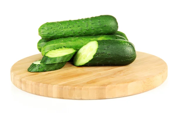 Tasty green cucumbers on wooden cutting board, isolated on white — Stock Photo, Image