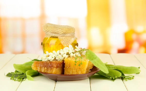 Burk honung med blommor av kalk, acacia på trä färgtabell på ljus bakgrund — Stockfoto
