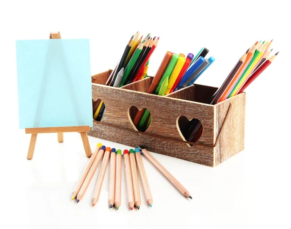 Different pencils in wooden crate and easel, isolated on white — Stock Photo, Image