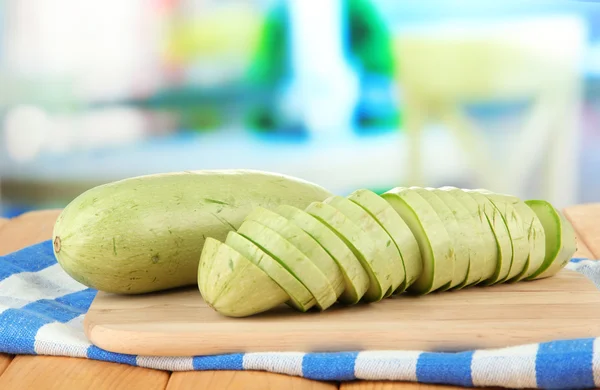 Fresh marrows on cutting board, on wooden table, on bright background — Stock Photo, Image