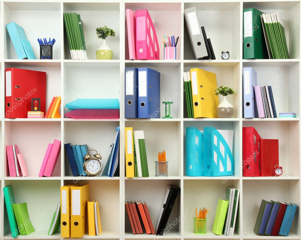 White office shelves with different stationery, close up