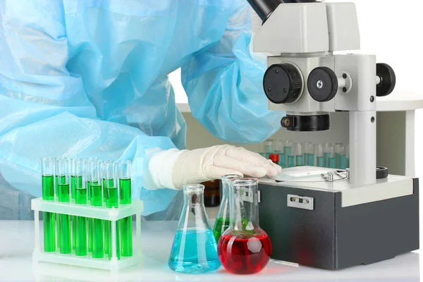 Scientist conducting research looking through microscope selective focus close up — Stock Photo, Image