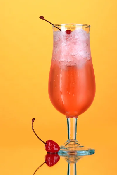 Cherry cocktail with ice on orange background — Stock Photo, Image