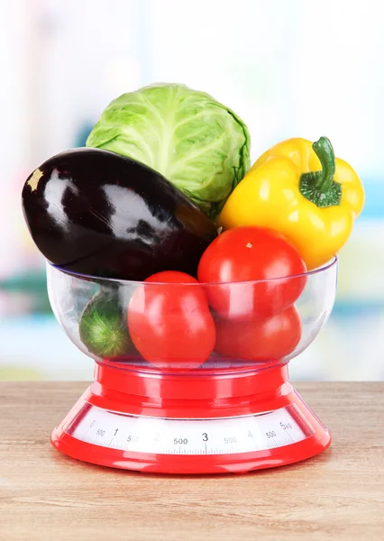 Fresh vegetables in scales on table in kitchen — Stock Photo, Image