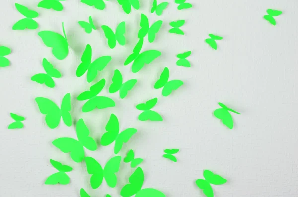 Paper butterflies fly on wall in different directions — Stock Photo, Image