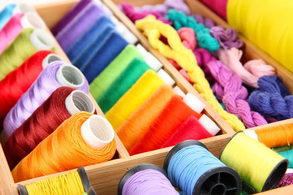 Colorful threads for needlework in wooden box close up — Stock Photo, Image