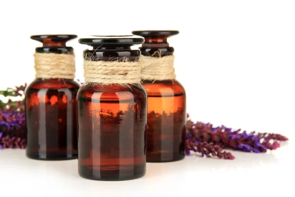 Medicine bottles and salvia flowers, isolated on white — Stock Photo, Image