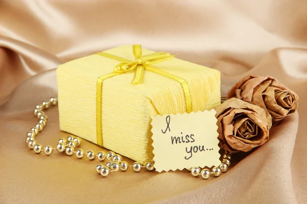 Romantic parcel on gold cloth background — Stock Photo, Image