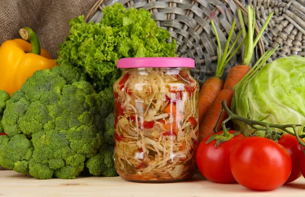Fresh vegetables and canned on wooden table close up — Stock Photo, Image