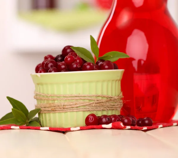 Pitcher of cranberry juice and red cranberries on table — Stock Photo, Image