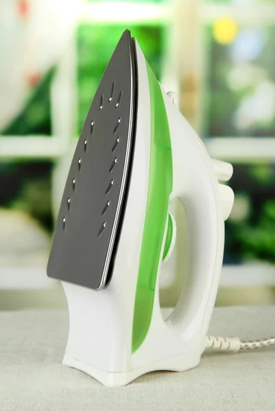 Steam iron on bright background