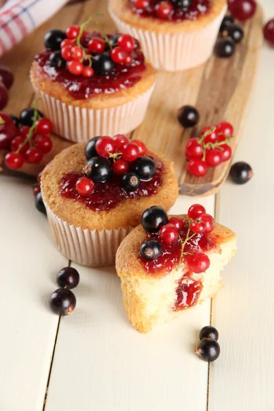 Chutné muffiny s ovocem na bílý dřevěný stůl — Stock fotografie