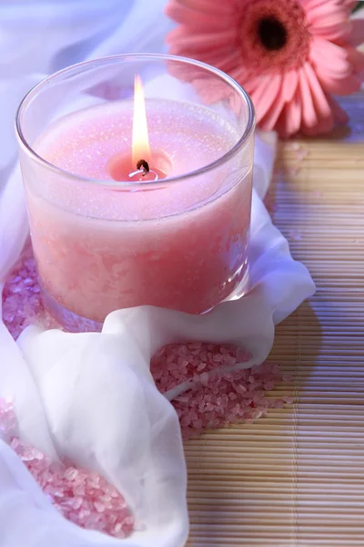 Beautiful candle with flower on white cloth, close up — Stock Photo, Image