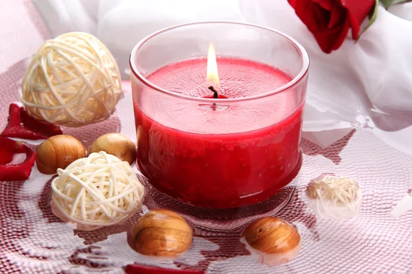 Beautiful red candle with flower petals in water — Stock Photo, Image