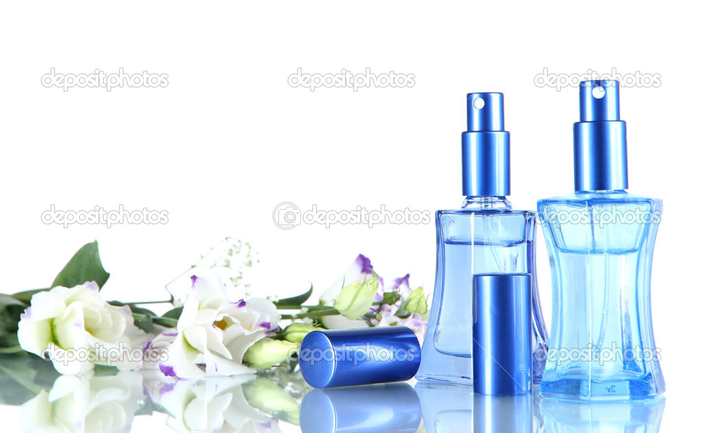 Perfume in bottles and flowers isolated on white