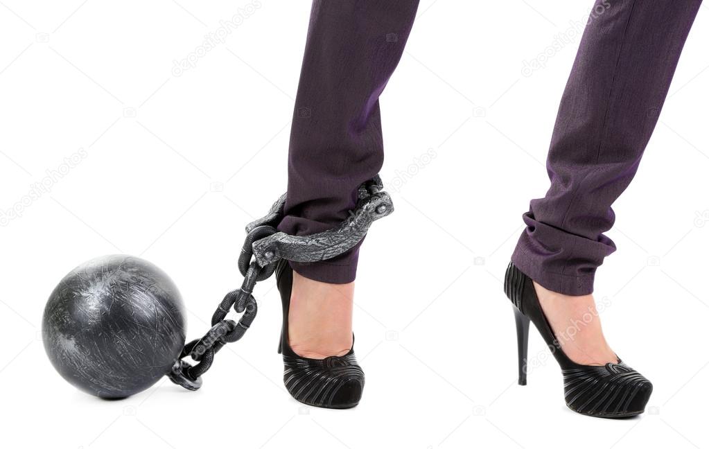 Business worker with ball and chain attached to foot isolated on white