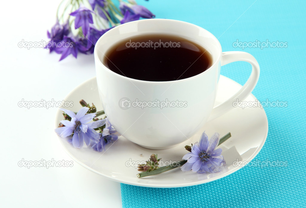 Cup of tea with chicory, isolated on white