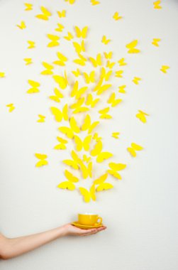 Paper yellow butterflies fly out of cup clipart