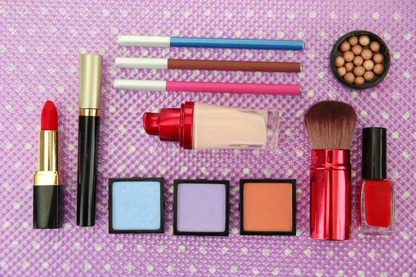 Decorative cosmetics on purple background — Stock Photo, Image