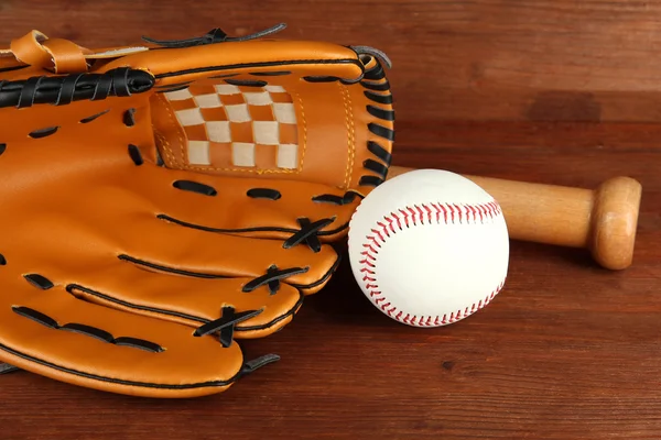 Baseball glove, bat and ball on wooden background — Stock Photo, Image