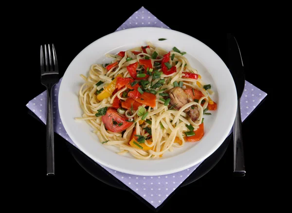 Noodles with vegetables on plate isolated on black — Stock Photo, Image