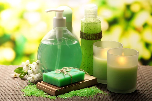 Garrafas de cosméticos e sabão artesanal natural em fundo verde — Fotografia de Stock