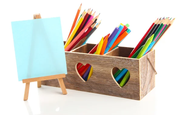 Different pencils in wooden crate and easel, isolated on white — Stock Photo, Image