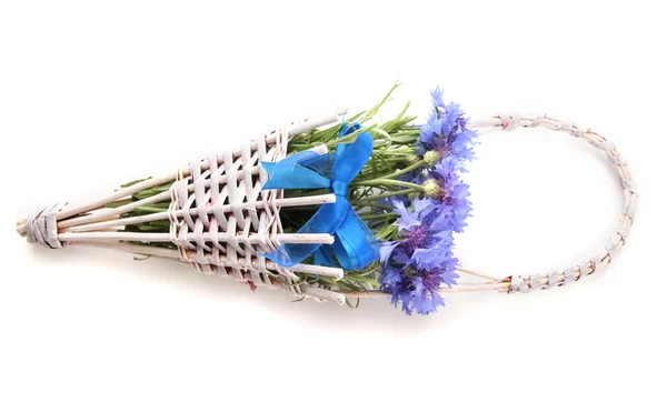 Beautiful bouquet of cornflowers in basket, isolated on white — Stock Photo, Image