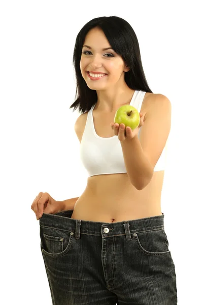 Beautiful young woman with big jeans and measuring tape isolated on white — Stock Photo, Image