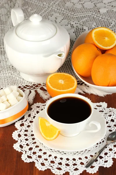 Beautiful white dinner service with oranges on wooden table close-up — Stock Photo, Image