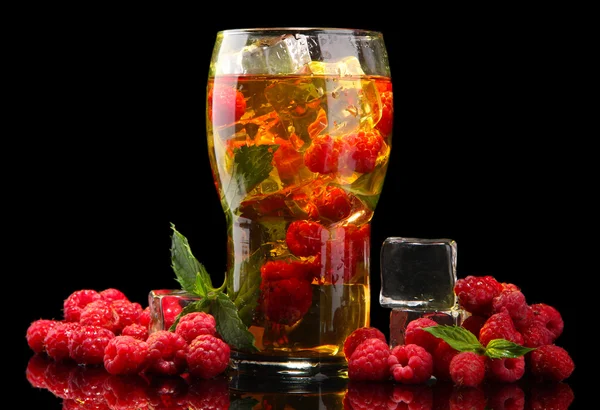 Iced tea with raspberries and mint on black background — Stock Photo, Image