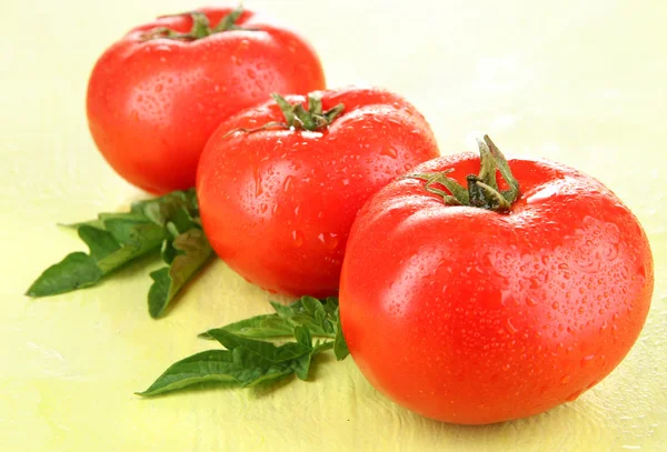 Fresh tomatoes on colour wooden backgroun — Stock Photo, Image