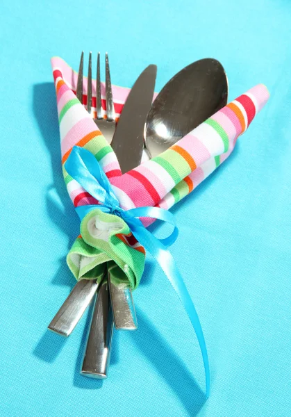 Fork,spoon,knife in napkin on bright background — Stock Photo, Image