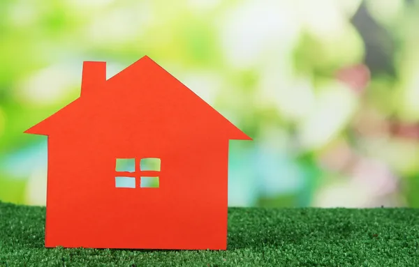 Paper house on grass on natural background — Stock Photo, Image