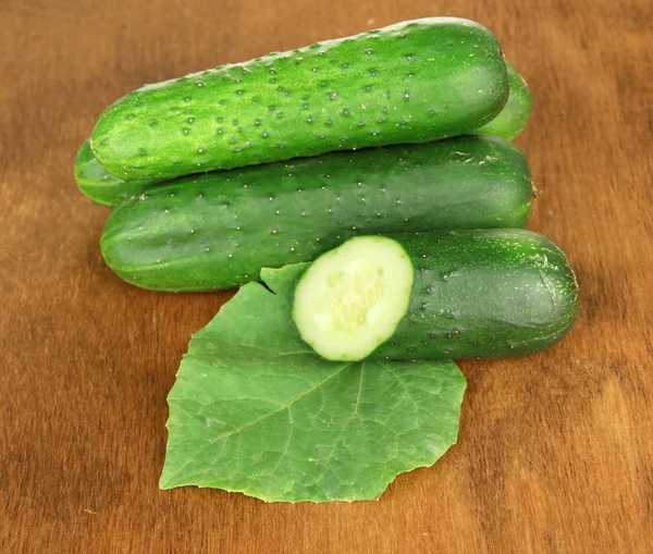 Tasty green cucumbers on wooden background — Stock Photo, Image