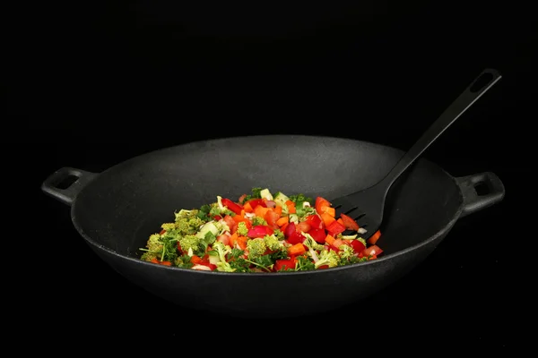 Vegetable ragout in wok, isolated on black — Stock Photo, Image