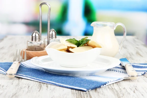 Tasty dumplings on white plate, on bright background — Stock Photo, Image
