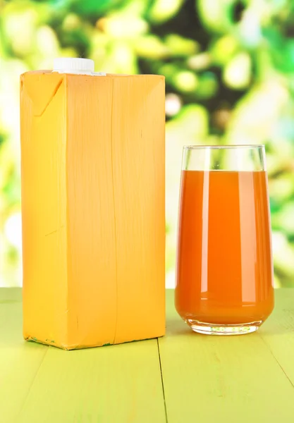 Juice pack on table on bright background — Stock Photo, Image