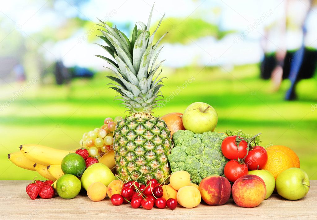 Assortment of fresh fruits and vegetables on natural background