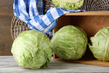 Cabbage on table on wooden background clipart