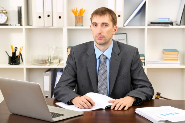 Young businessman in office at his workplace — Stock Photo, Image