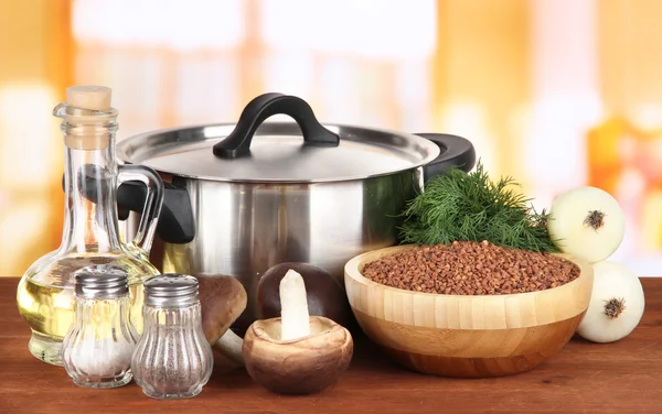 Ingredients for cooking buckwheat on table in kitchen — Stock Photo, Image