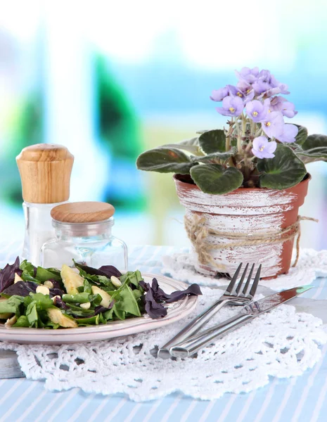 Light salad on plate on table on room background — Stock Photo, Image