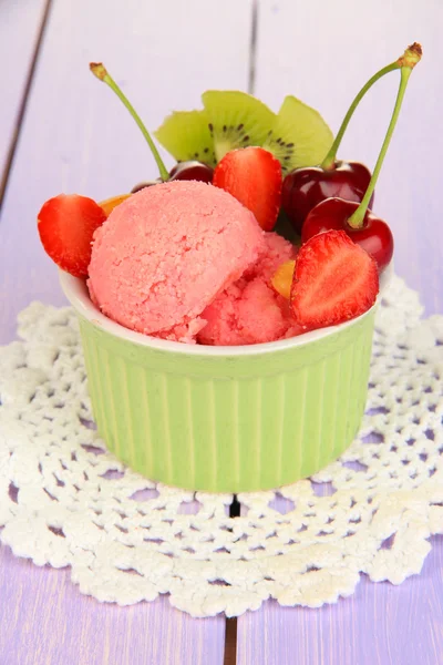 Delicious ice cream with fruits and berries in bowl on wooden table — Stock Photo, Image