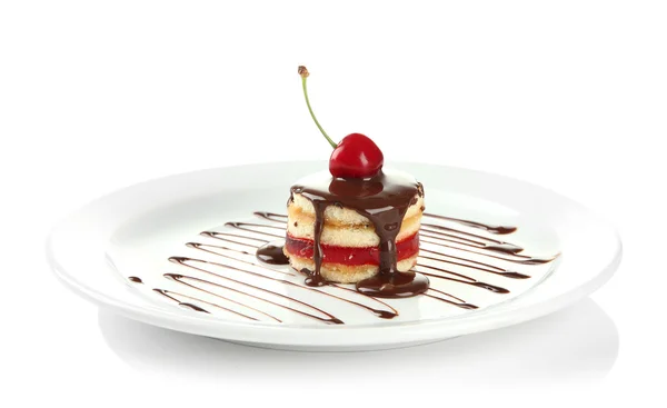 Tasty biscuit cake with chocolate and berry on plate, isolated on white — Stock Photo, Image