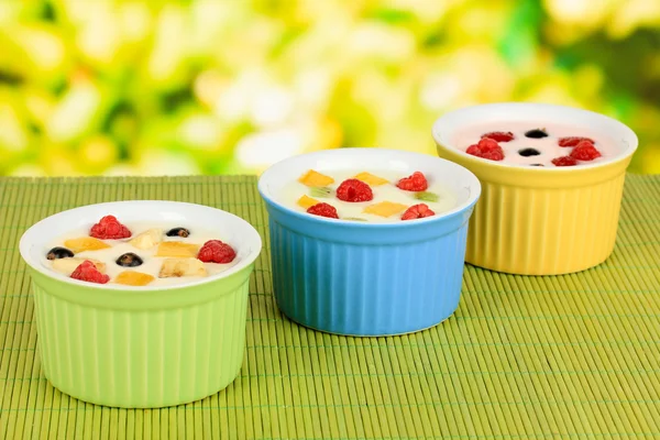 Läckra yoghurt med frukt på tabellen på ljus bakgrund — Stockfoto