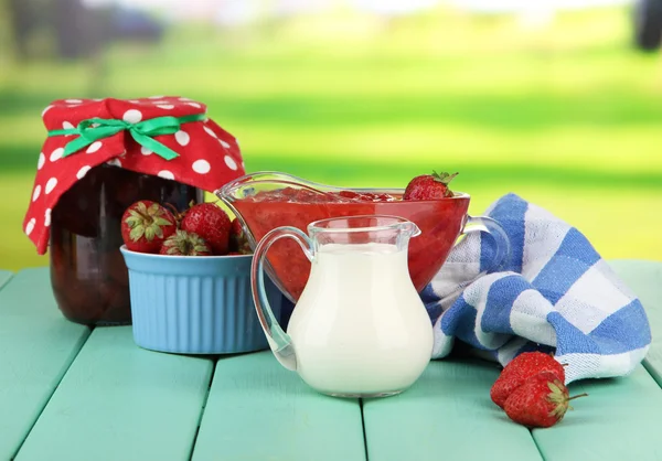 Homemade strawberry jam, on napkin, on color wooden table, on bright background — Stock Photo, Image